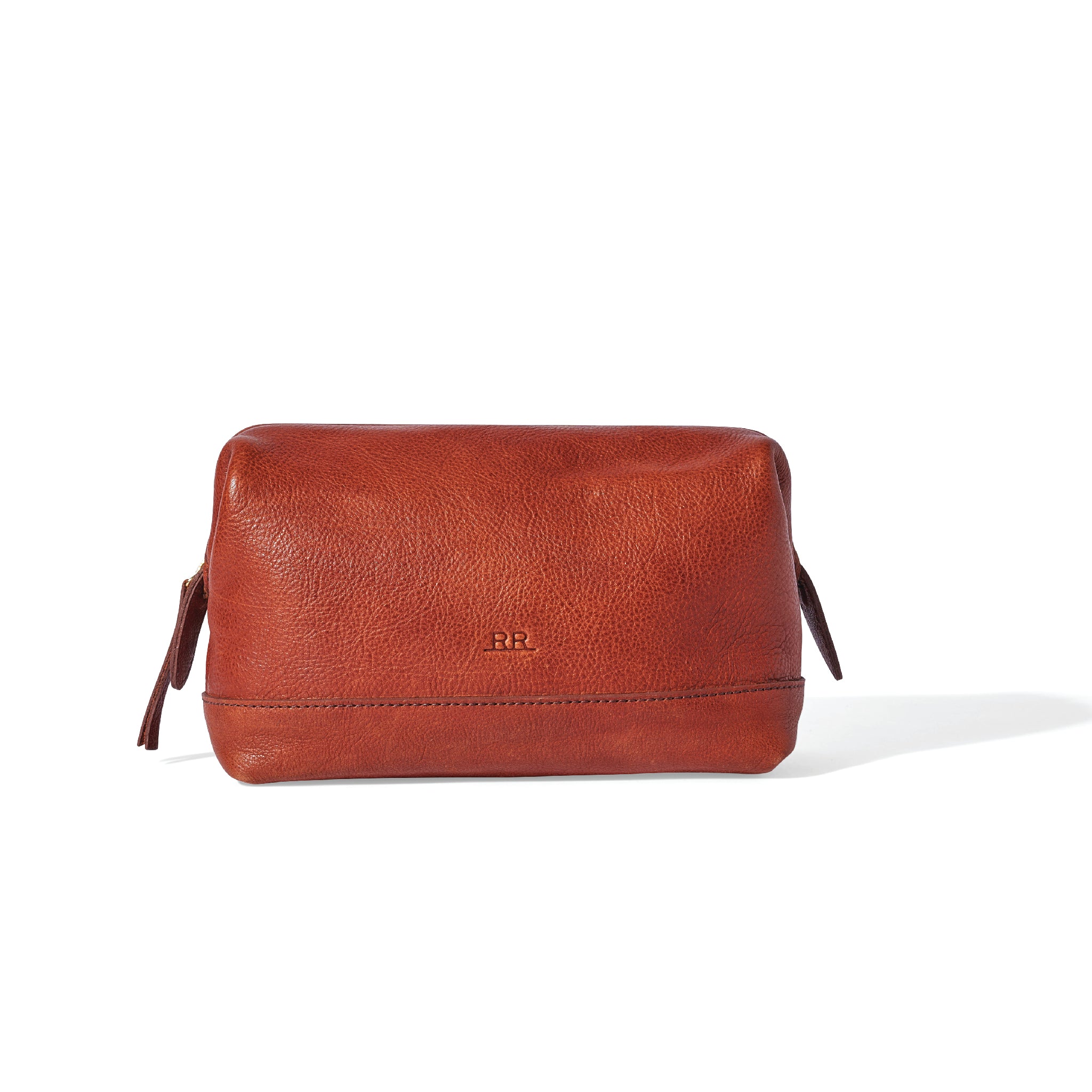 Mahogany brown leather dopp kit with structured base and wide framed zip opening
