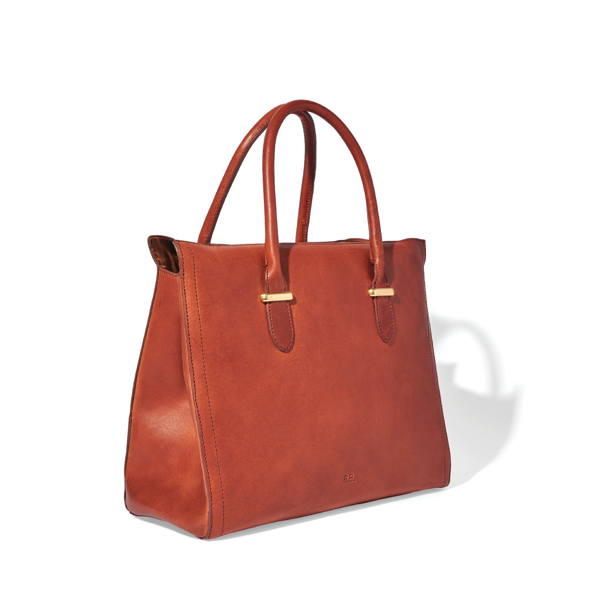 Mahogany brown leather satchel with rolled handles, side snaps, and brass feet