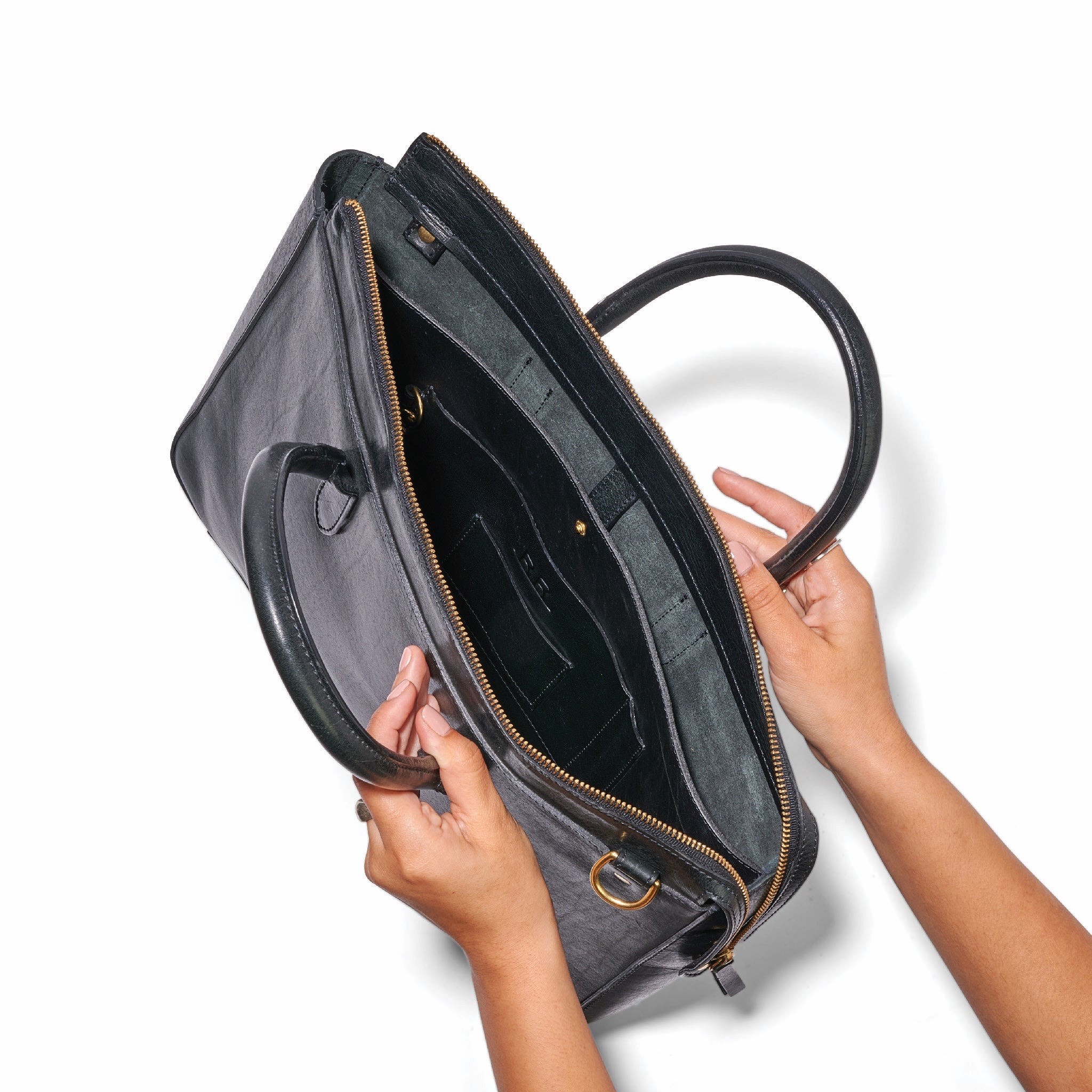 Black leather briefcase with adjustable strap, brass hardware, and sleek profile