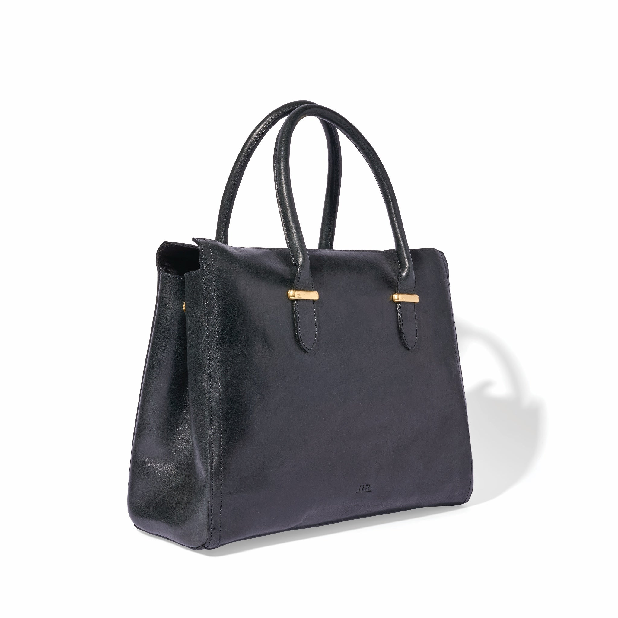 Regenerative leather satchel shown open with spacious interior and brass hardware