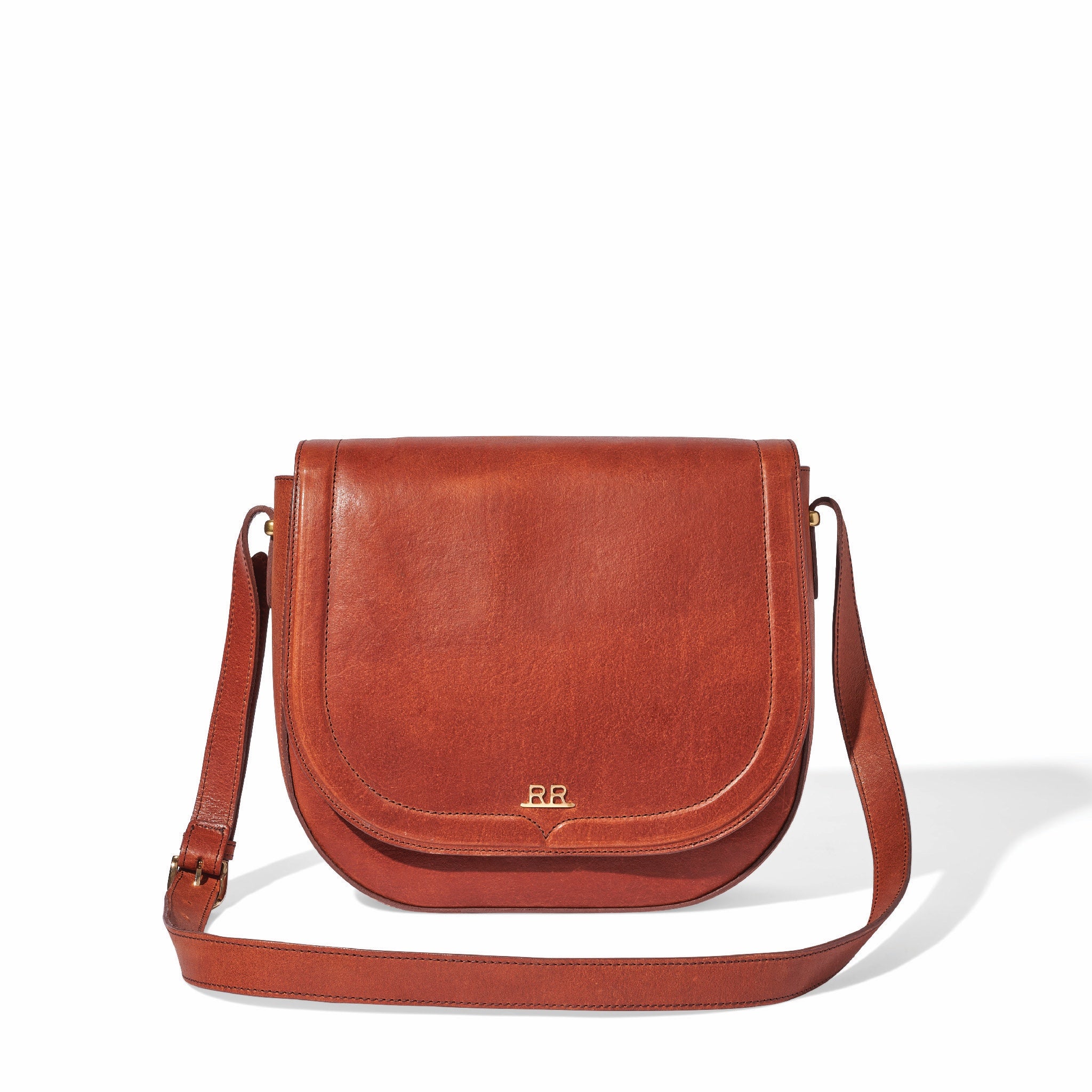 Mahogany brown leather saddle bag with magnetic flap and lined interior pocket