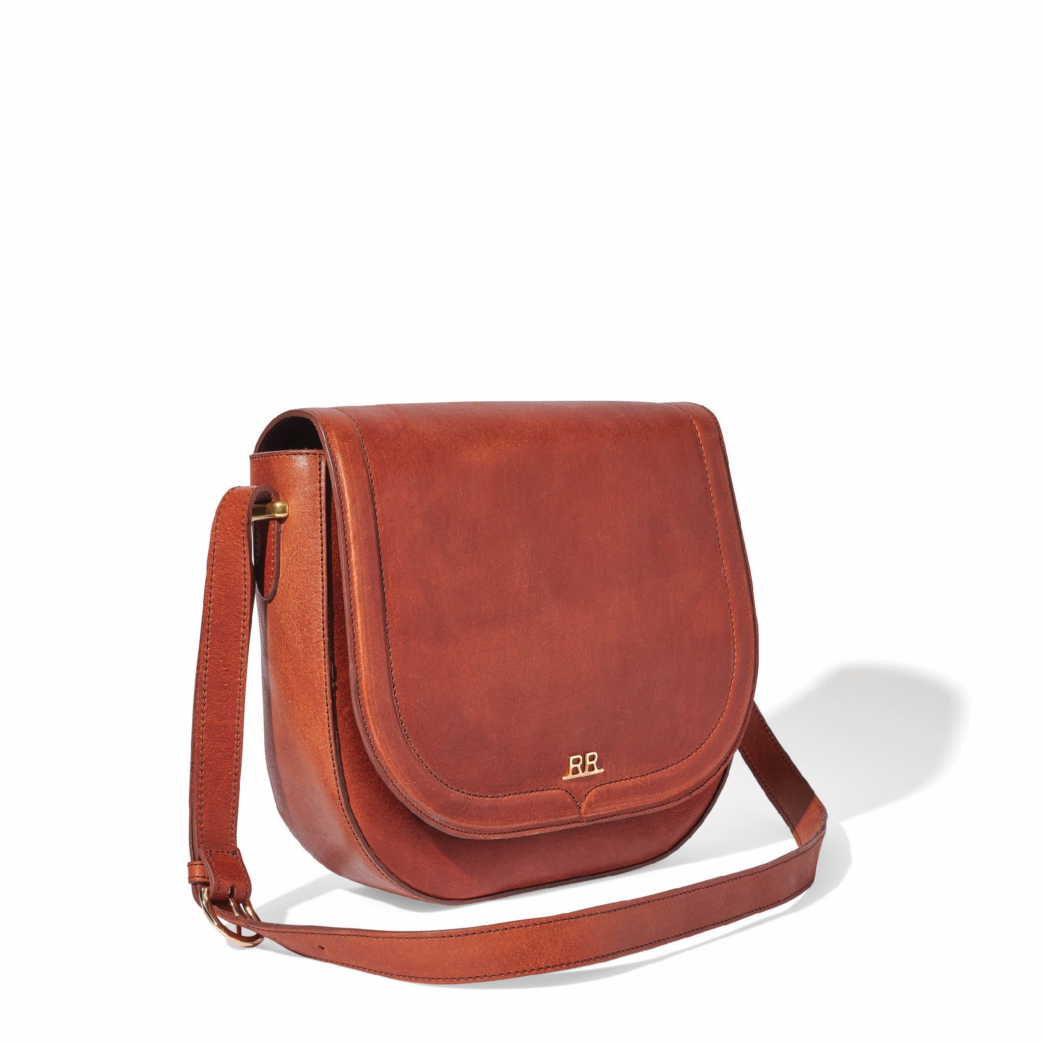 Mahogany brown leather saddle bag with magnetic flap and lined interior pocket