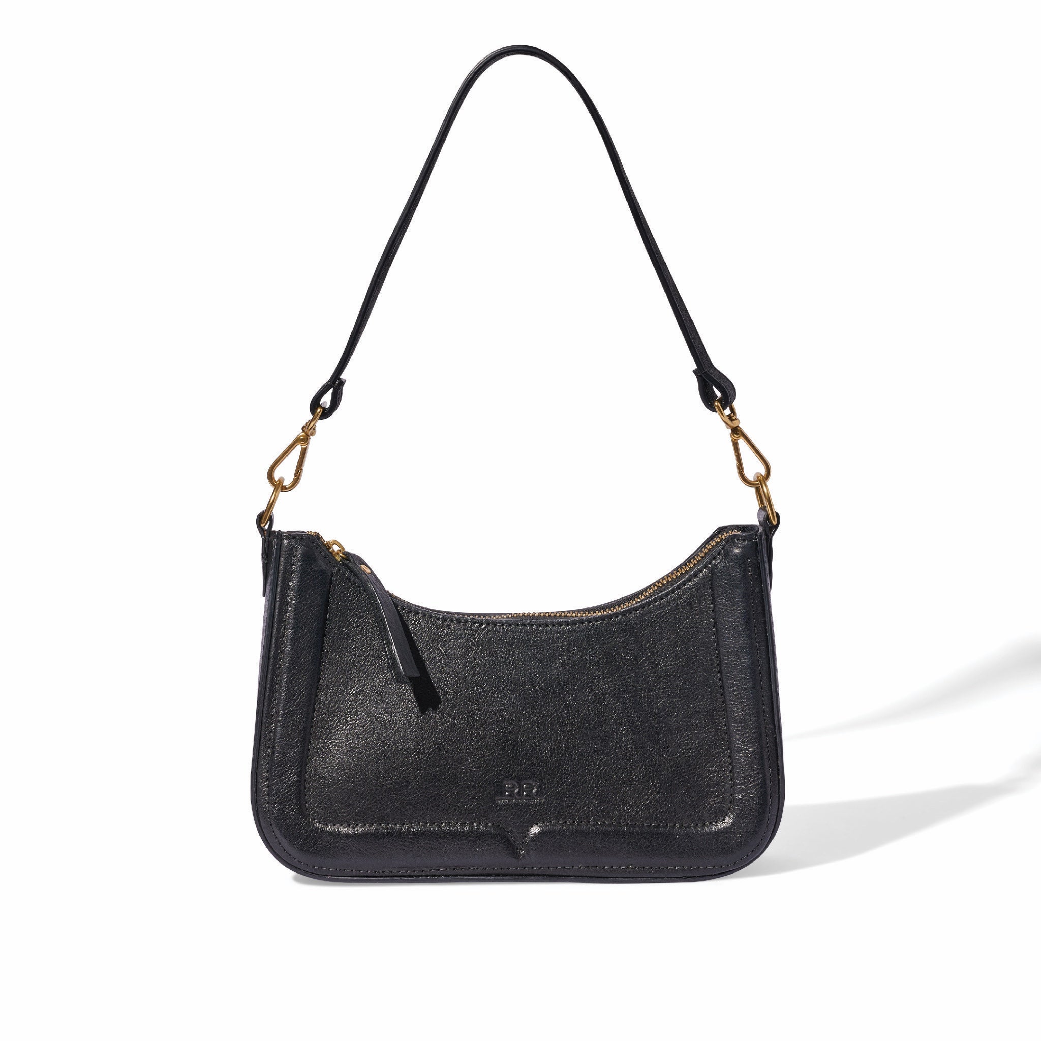 Sleek shoulder bag with western-inspired details, zip closure, and lined interior. Handcrafted from regenerative leather for modern, everyday elegance.