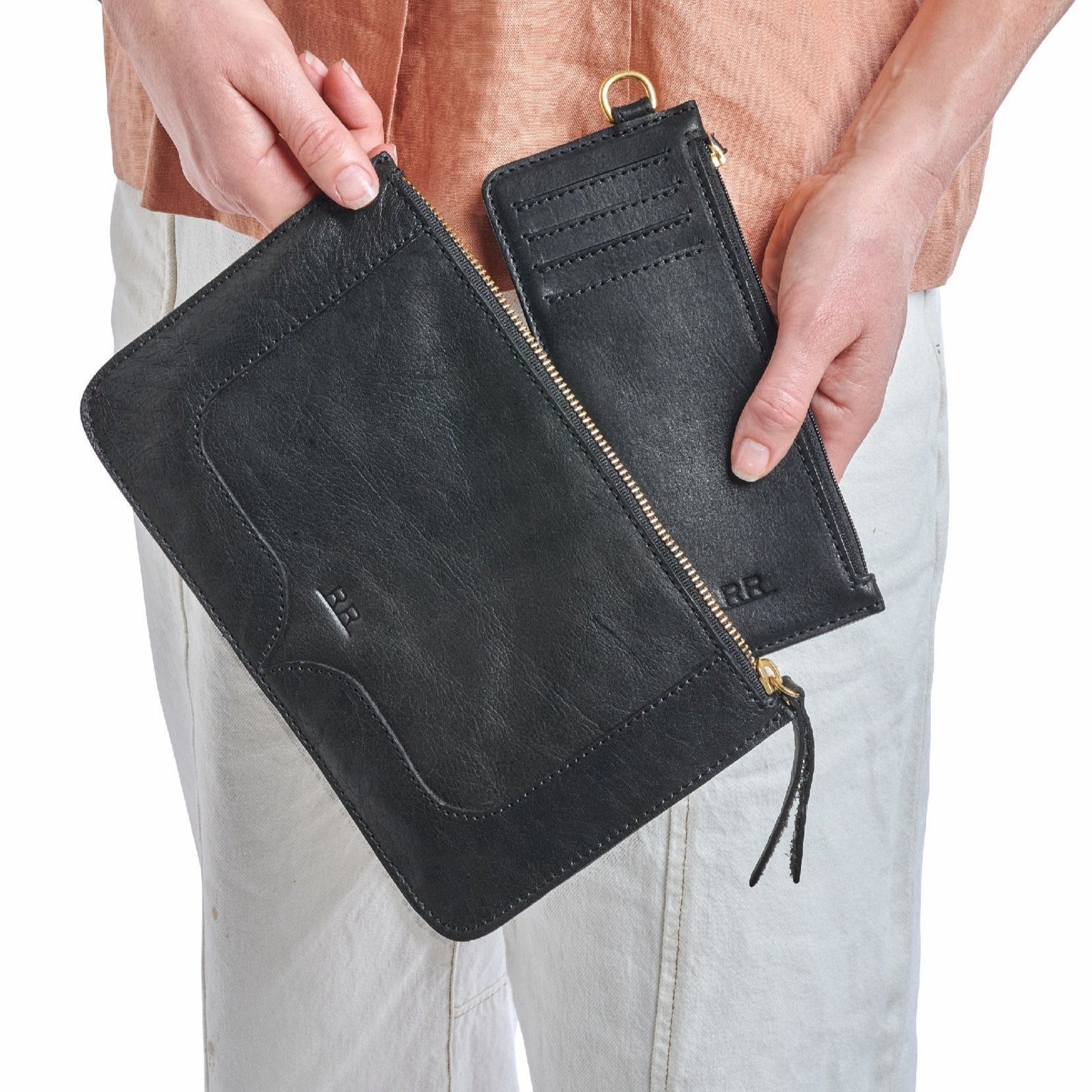 Black leather slim wallet with zip closure, card slots, and full-length bill compartment