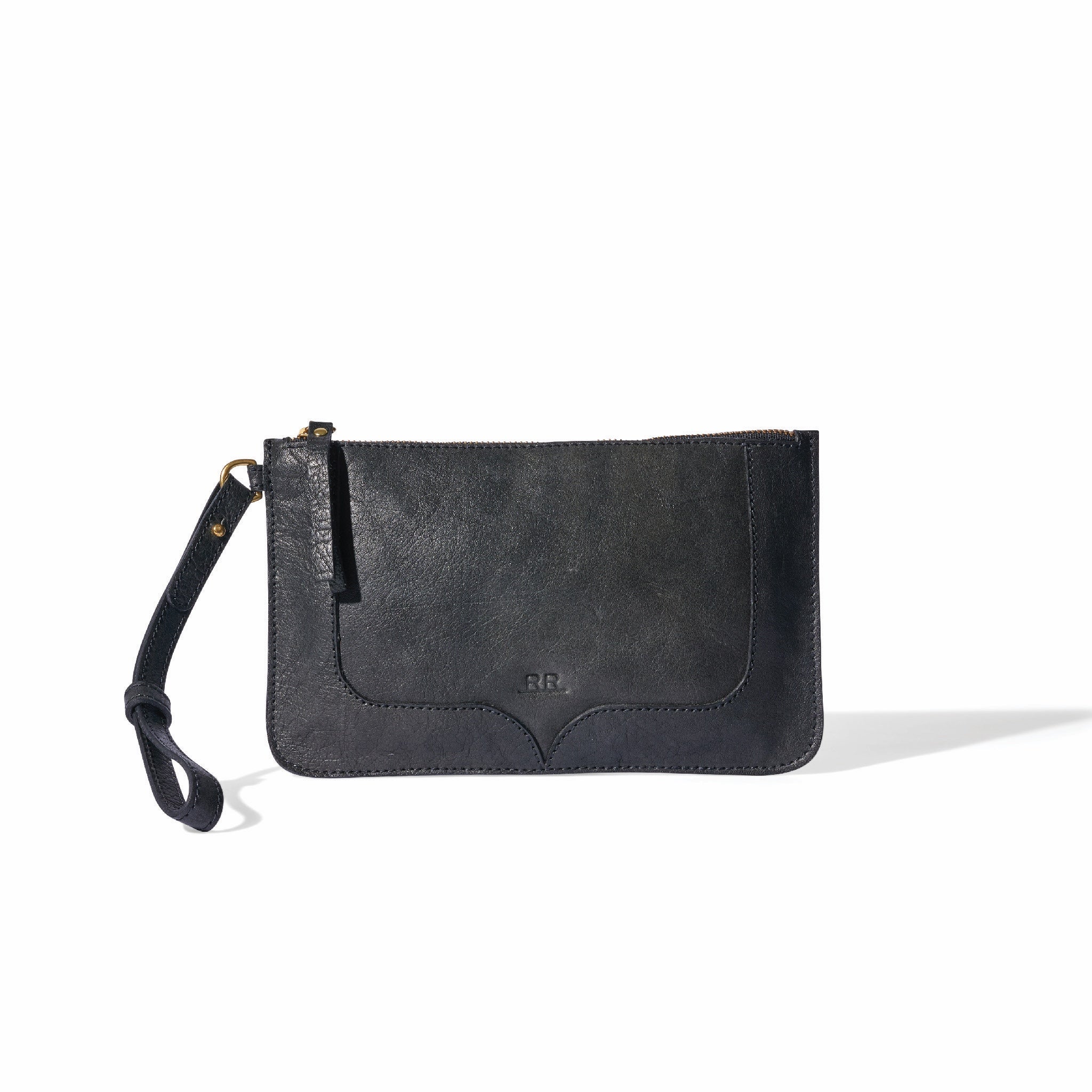 Black wristlet with brass hardware, lined interior, and versatile carry design